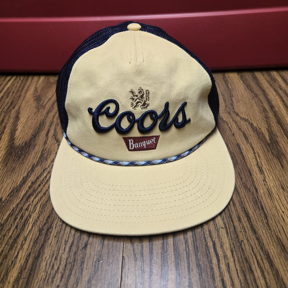 American Needle Coors Banquet Yellow and Navy Snap Back Mesh Trucker Hat.